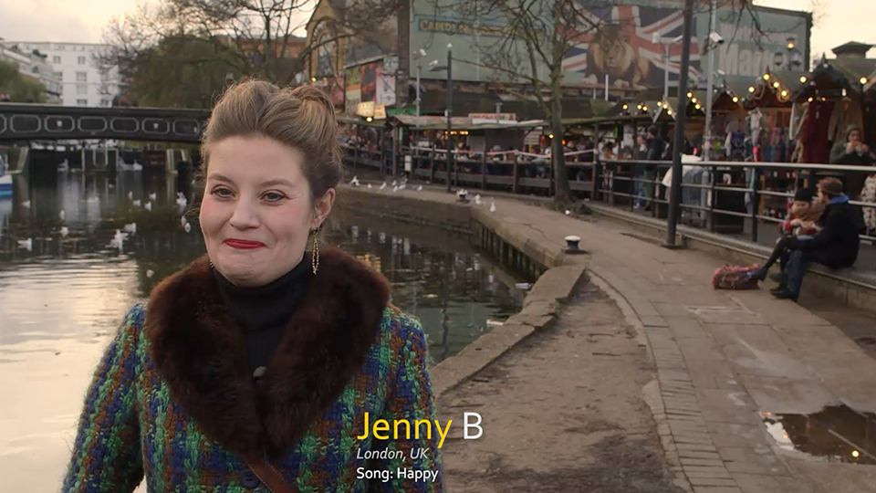 Portrait of Jenny B by a canal in London, with a text overlay reading 'Jenny B', 'London, UK', 'Song: Happy'.