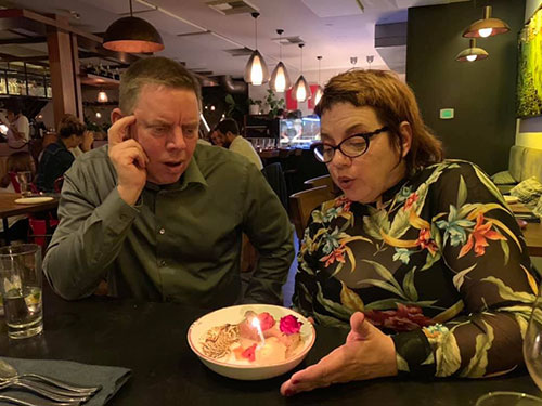Couple look upon their anniversary desert with awe, wonder, and love